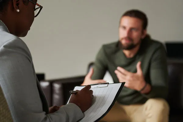 Man receiving therapy from a psychologist